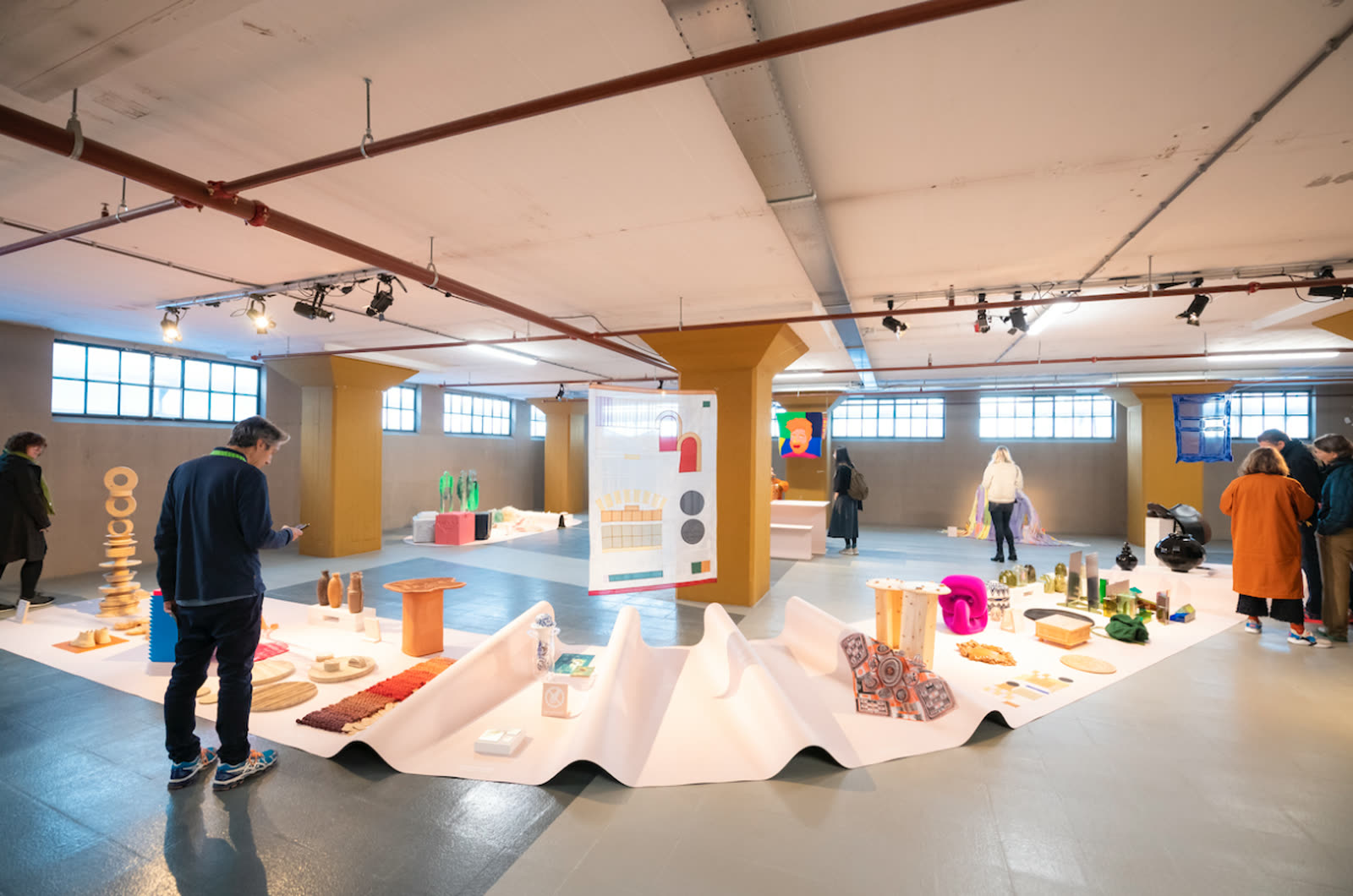 Design fair floor with material objects laid out for review