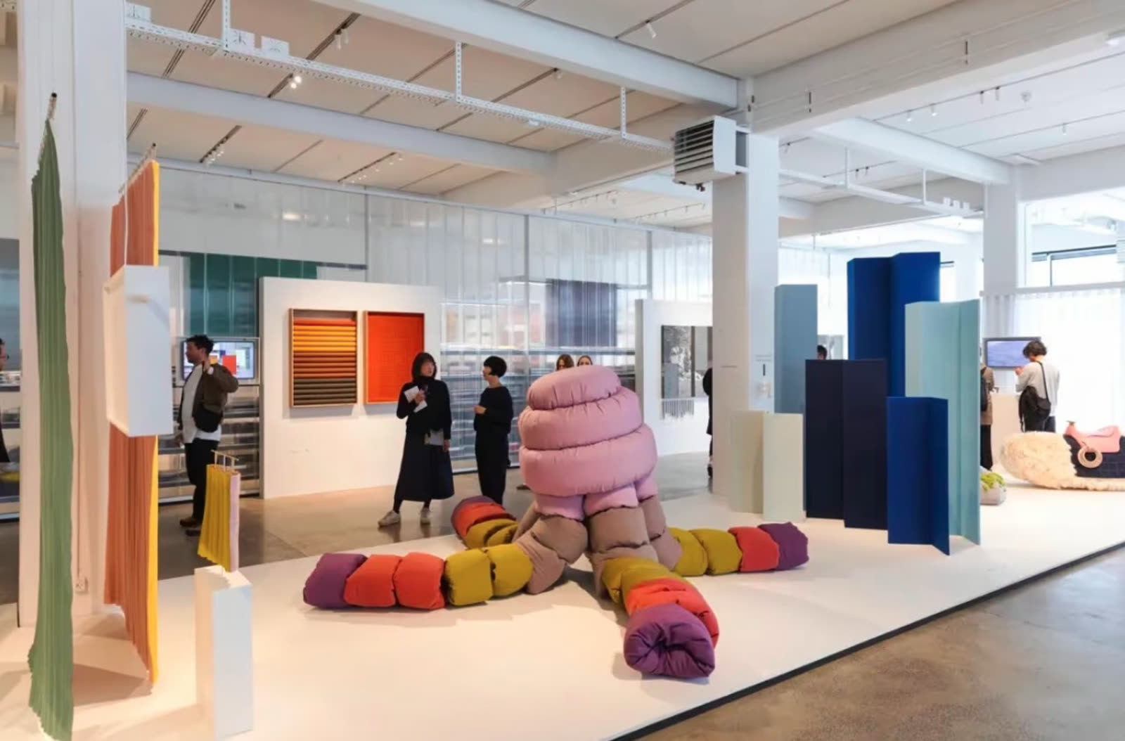 Installation hall with textile sculpture and visitors